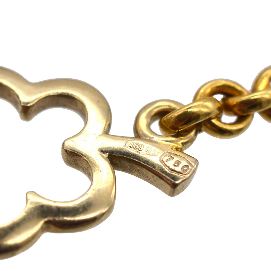 Close-up of a vintage 18ct gold link from Pomellato necklace, showcasing its iconic design and hallmark.