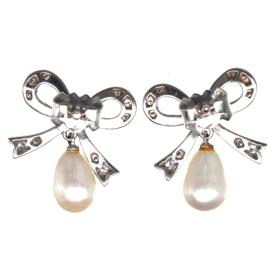 Vintage 18ct white gold diamond bow earrings with cultured pearl drops, perfect for brides or special occasions.