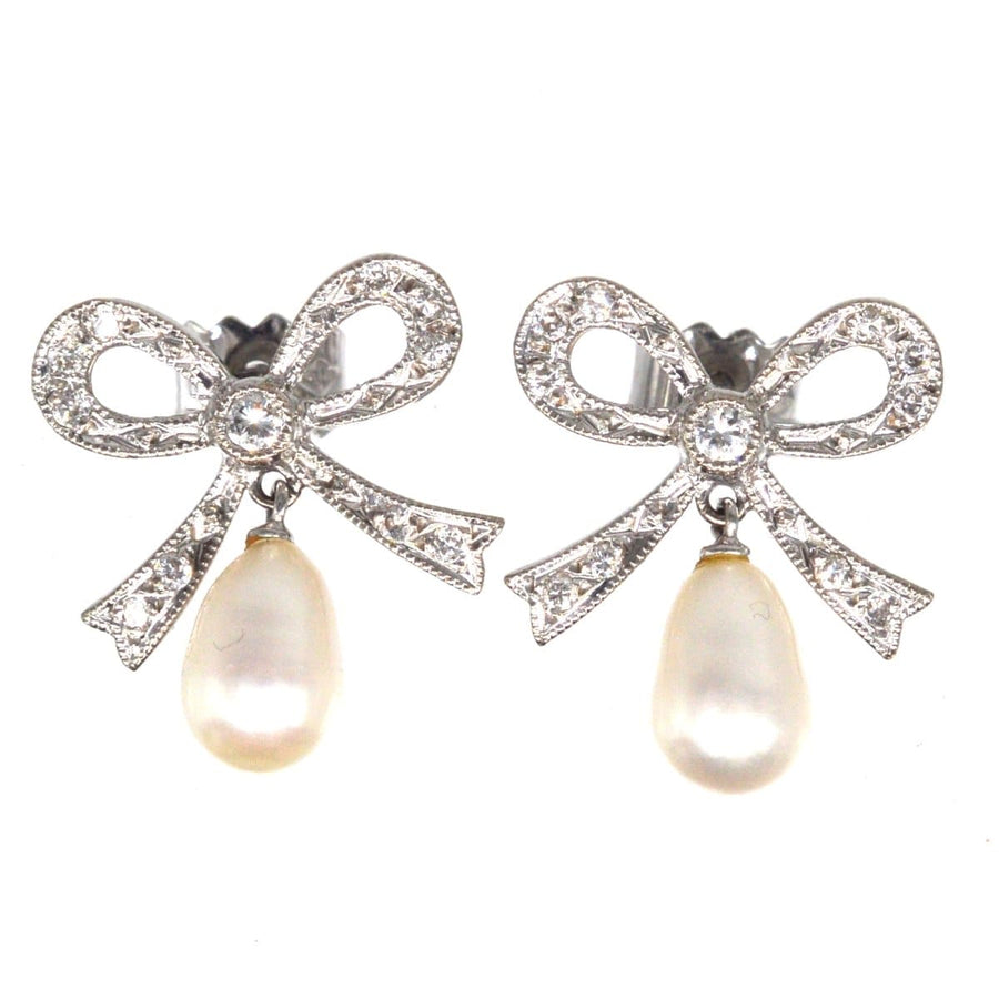Vintage 18ct white gold diamond bow earrings with cultured pearl drop, perfect for brides or special occasions.