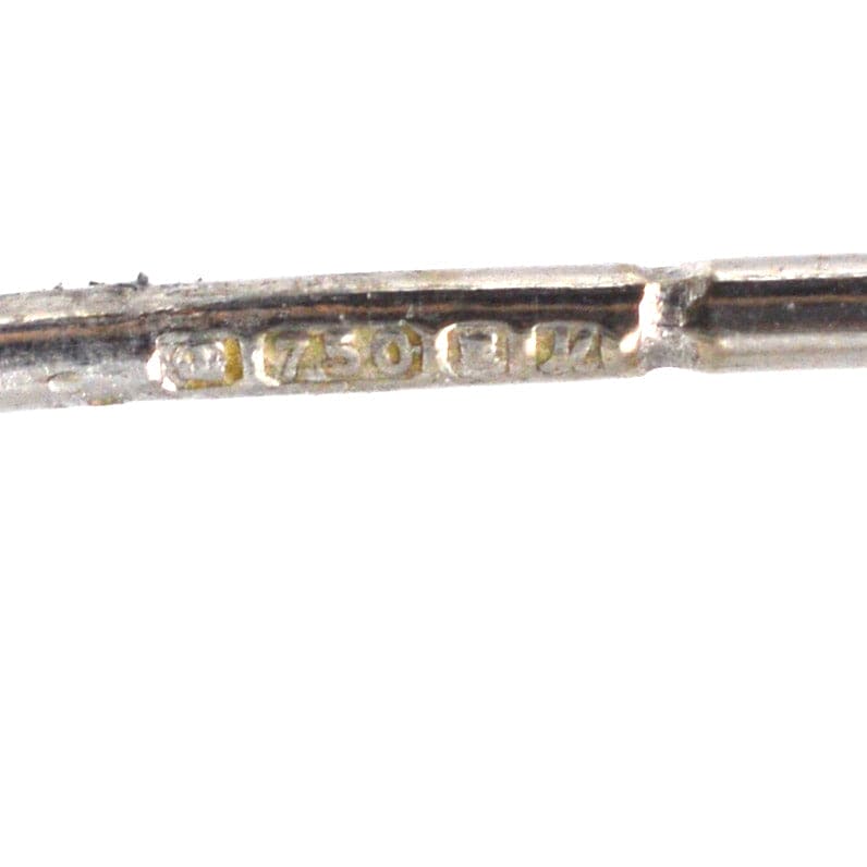 Close-up of a 750 hallmark on white gold jewelry, indicating 18ct purity for fine craftsmanship.