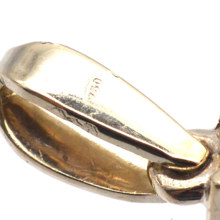 Close-up of vintage white gold pendant clasp detailing showing 18ct hallmark, showcasing craftsmanship and quality.