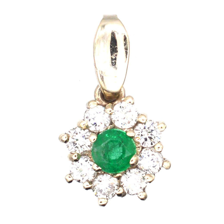 Vintage 18ct white gold pendant featuring emerald center surrounded by eight sparkling diamonds.