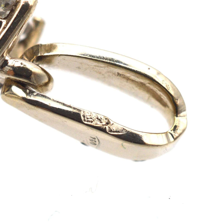Close-up of vintage 18ct white gold pendant setting with visible hallmark details.