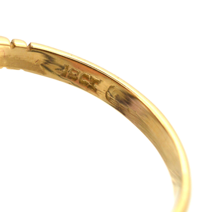 Close-up of the inner band of a vintage 1970s 18ct gold ring, showing hallmarks and craftsmanship details.