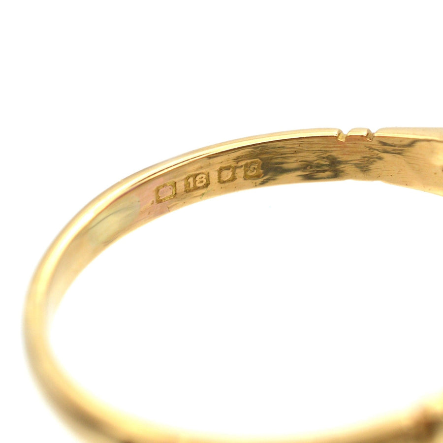 Close-up of the hallmark inside a vintage 1970s 18ct gold ring, featuring the purity mark and year of manufacture.