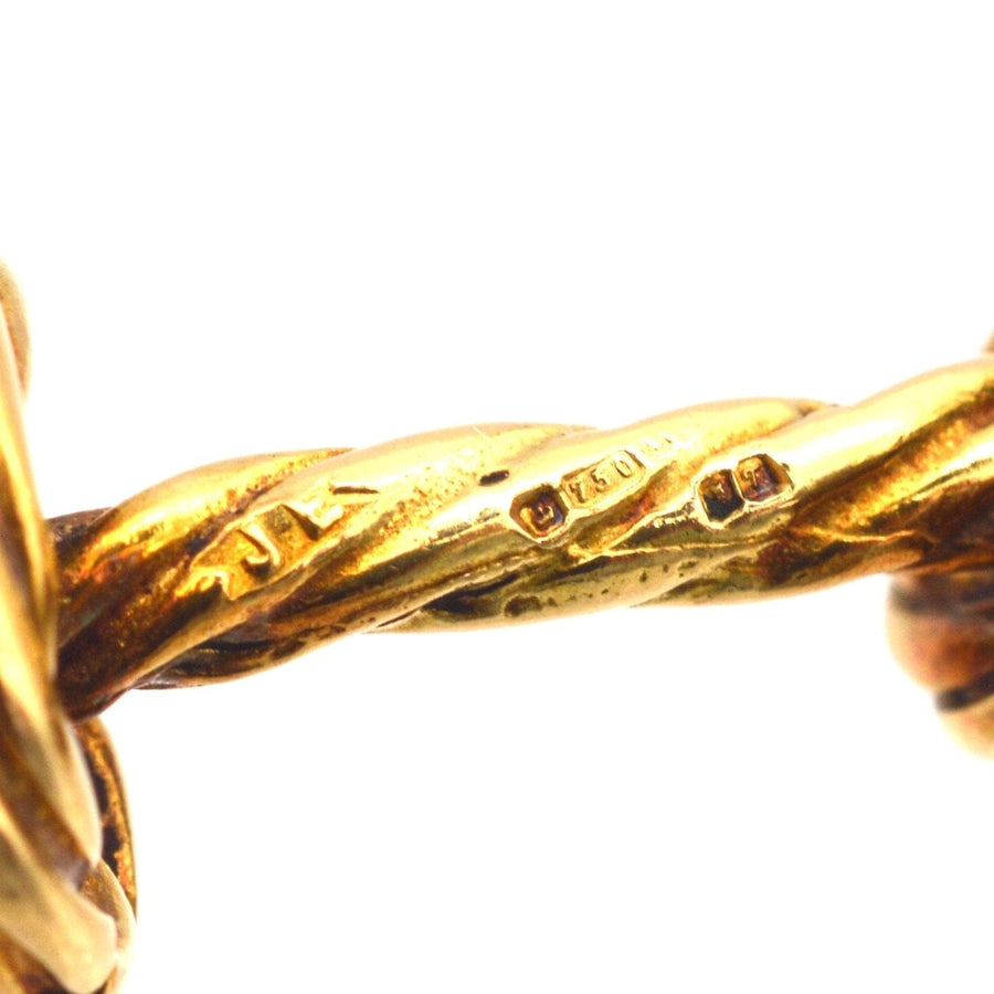 Close-up of vintage 1990s 18ct gold rope knot cufflinks showing intricate twisting design and hallmark details.