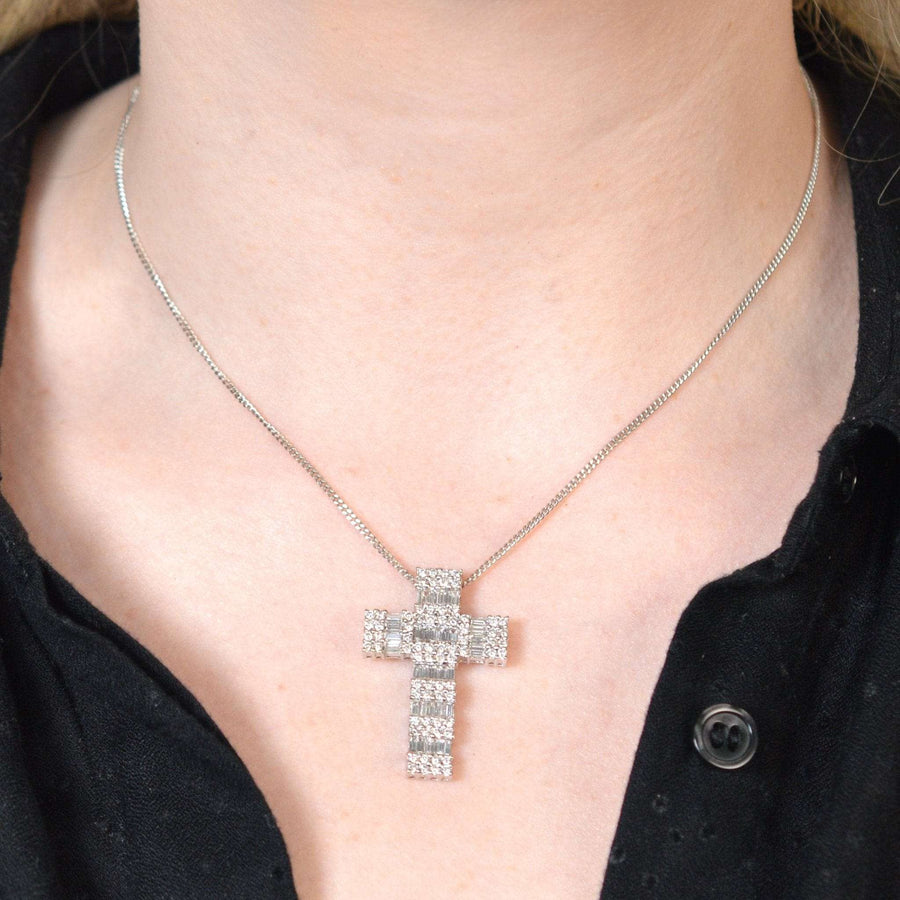 Vintage 1990s 18ct white gold cross pendant with 3 carats of diamond baguettes and round brilliant cuts, worn on a chain.