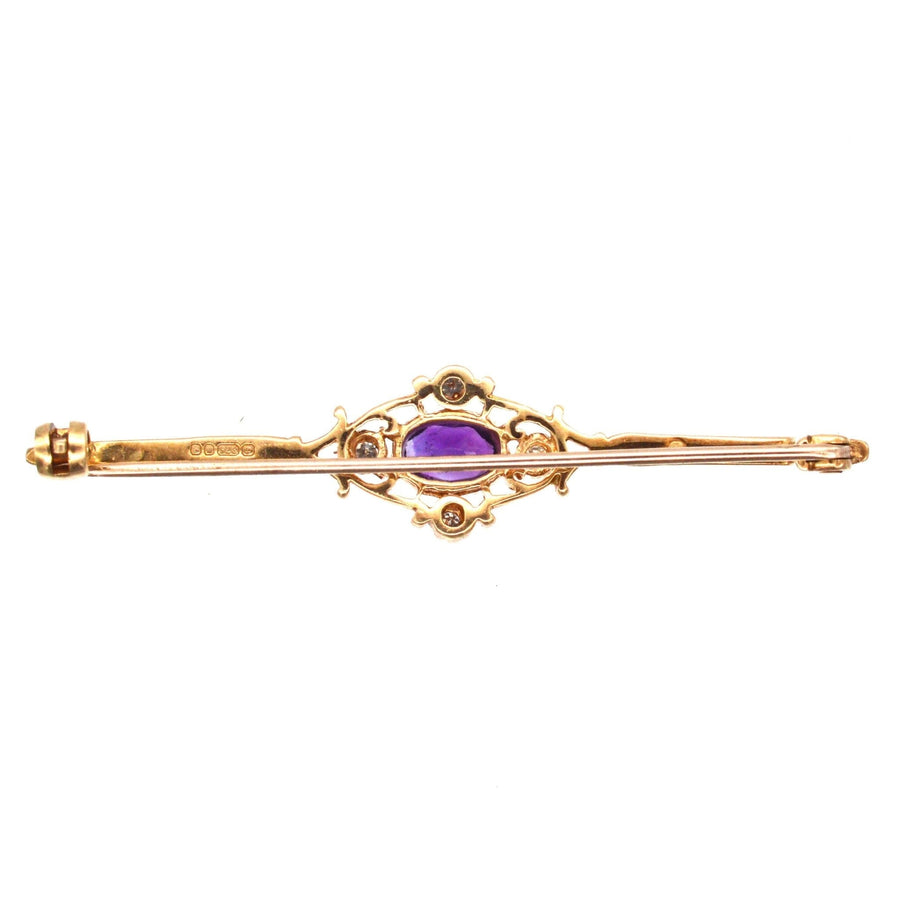 Vintage 9ct gold bar brooch with amethyst and diamond centerpiece, perfect for stylish attire.