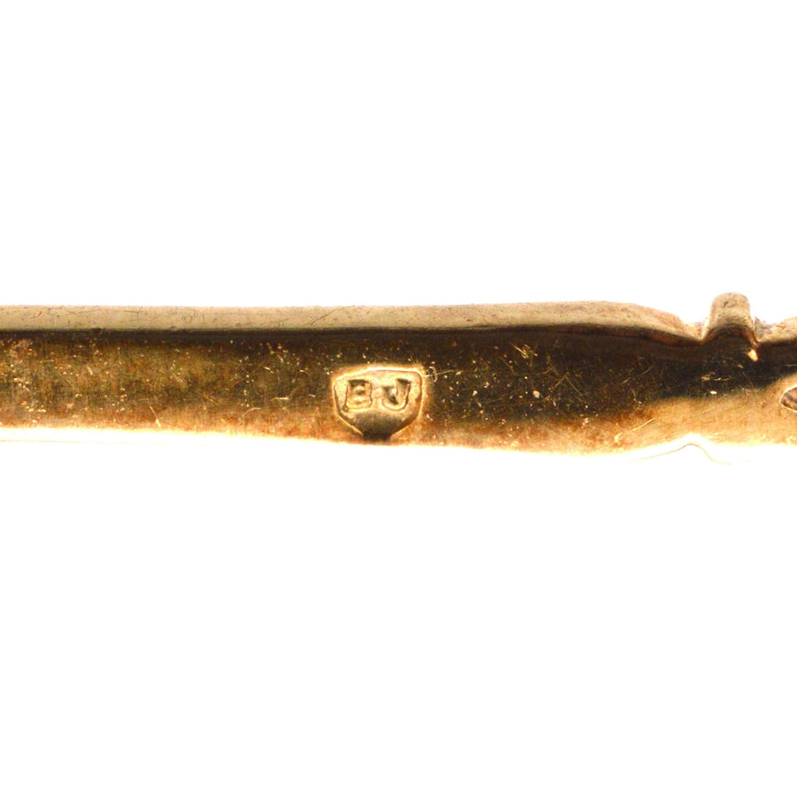 Vintage 9ct gold bar brooch with hallmark detail, showcasing exquisite craftsmanship and design.
