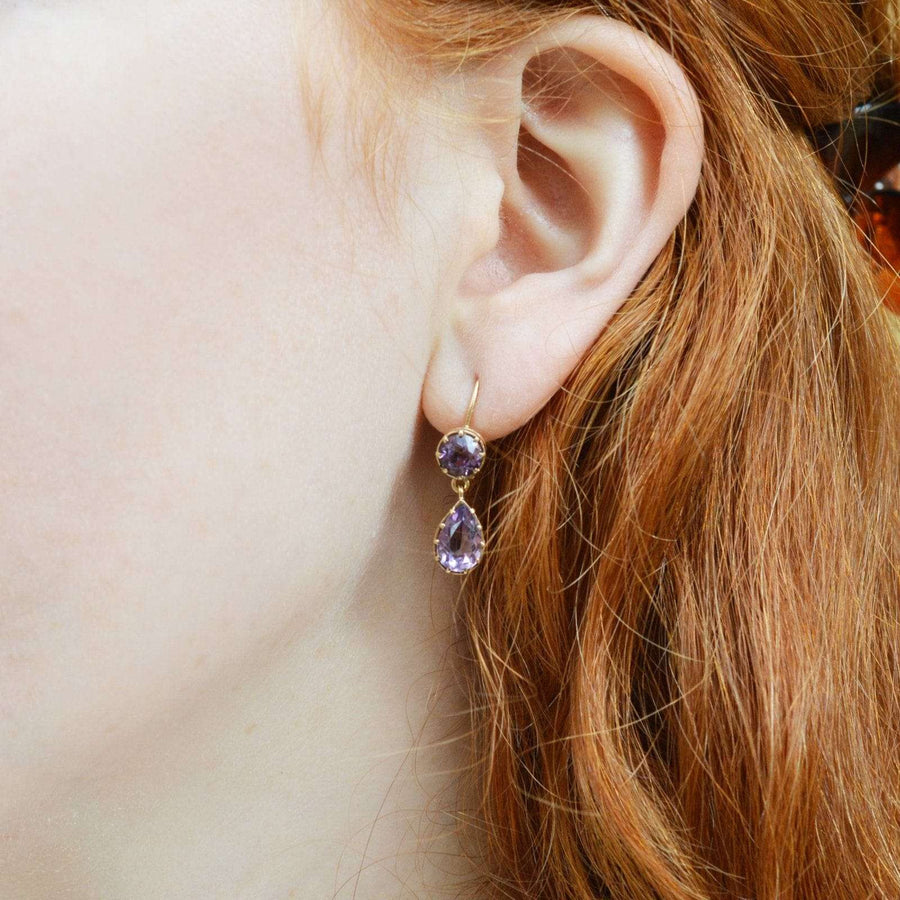 Vintage 9ct gold amethyst drop earrings worn by a model with red hair, showcasing royal purple gems.