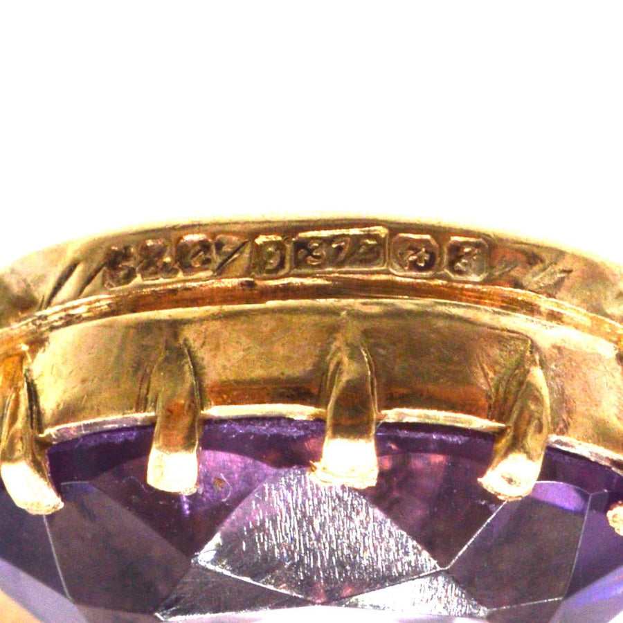 Close-up of vintage 9ct gold amethyst drop necklace, showing hallmark and setting details.