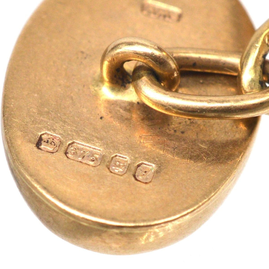 Close-up of vintage 9ct gold amethyst oval cufflinks showing hallmark and maker's mark for Etienne Wilfred Verniquet.