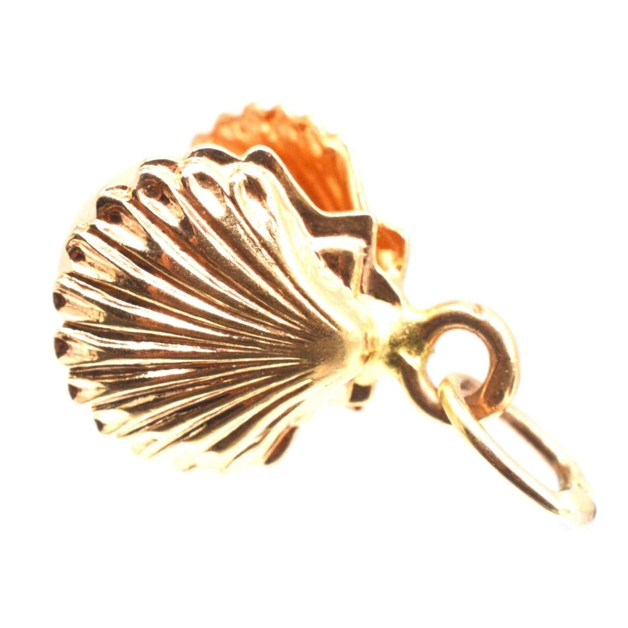 Vintage 9ct gold scallop shell charm pendant with imitation pearl, symbolizing hope and strength.