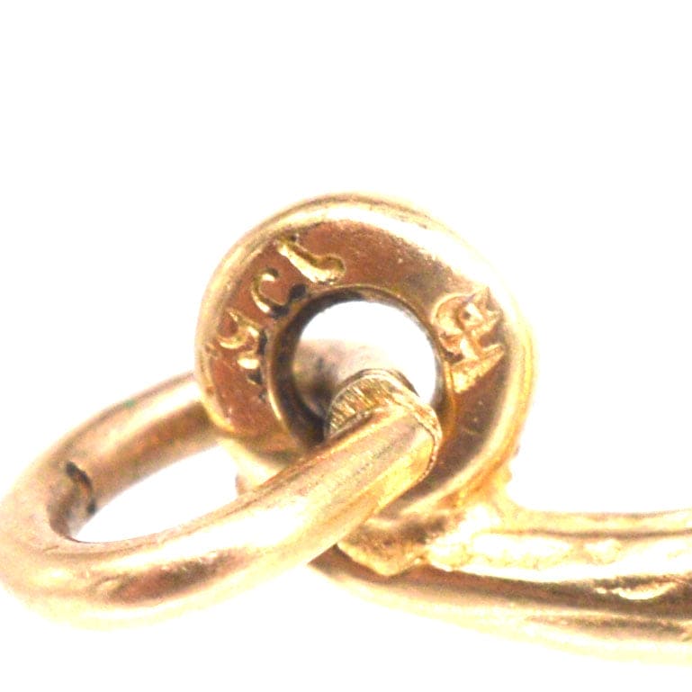 Close-up of a vintage 9ct gold crocodile charm's clasp, showcasing its intricate design and quality.