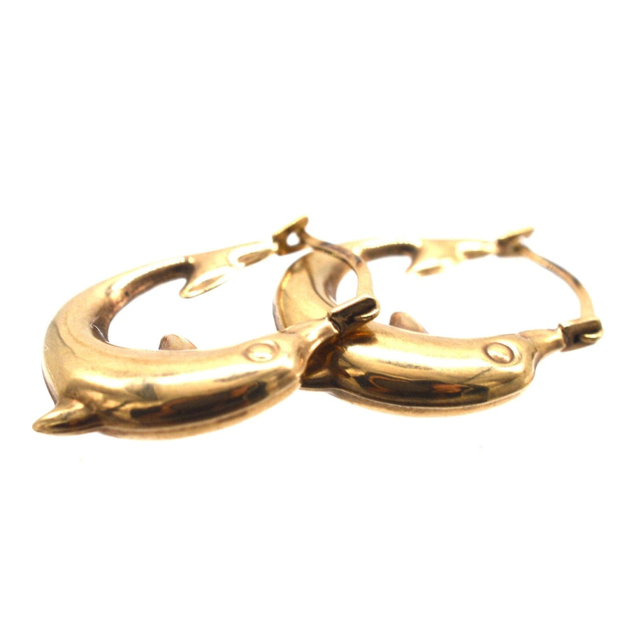 Vintage 9ct gold dolphin hoop huggie earrings, embodying beauty and playfulness, symbolizing harmony and grace.