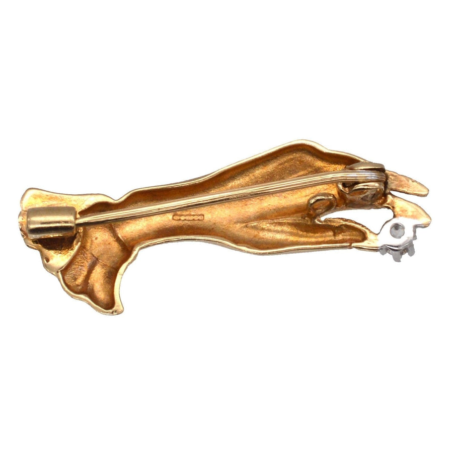 Vintage 9ct gold hand brooch holding a diamond, crafted in 1987, showcasing timeless elegance and charm.