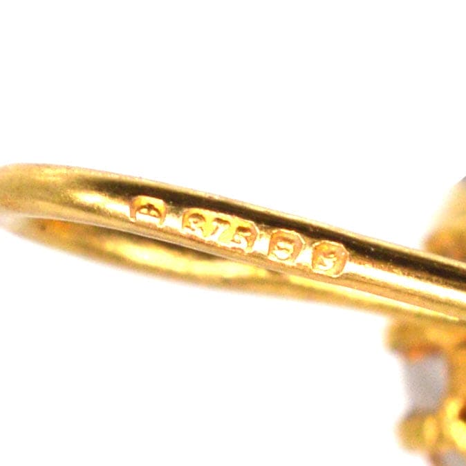 Close-up of the hallmark on a vintage 9ct gold earring, showcasing the gold quality and craftsmanship.