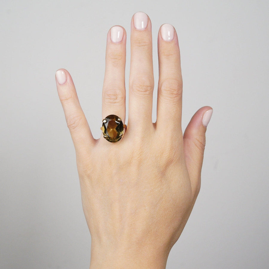 Vintage 9ct gold smoky quartz cocktail ring displayed on a woman's hand, showcasing its bold design and rich gemstone.
