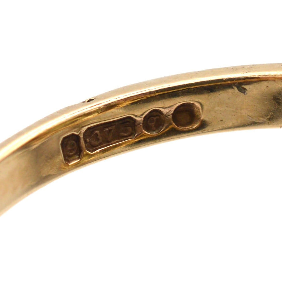 Close-up of 9ct gold assay marks on a vintage ring, showcasing its authenticity and craftsmanship.