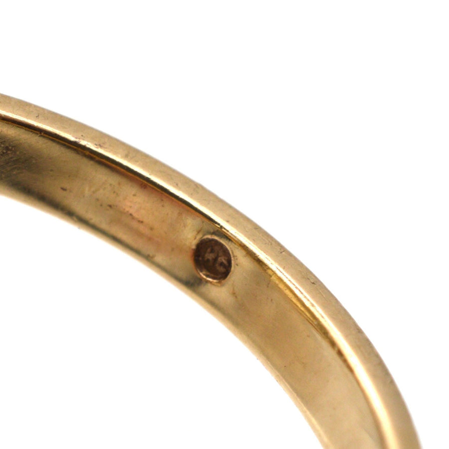 Close-up view of the inner band of a vintage 9ct gold ring showcasing the hallmark for authenticity.
