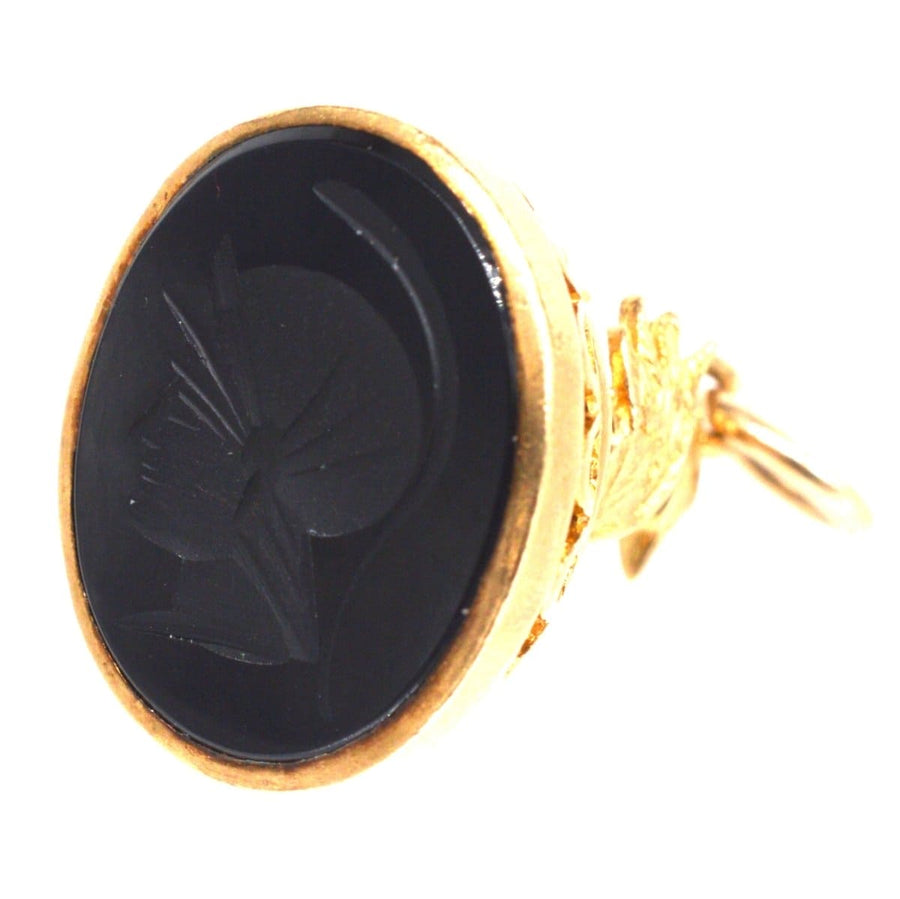 Vintage gold ring with black onyx seal featuring Hermes, the Messenger of Gods, showcasing intricate design and craftsmanship.