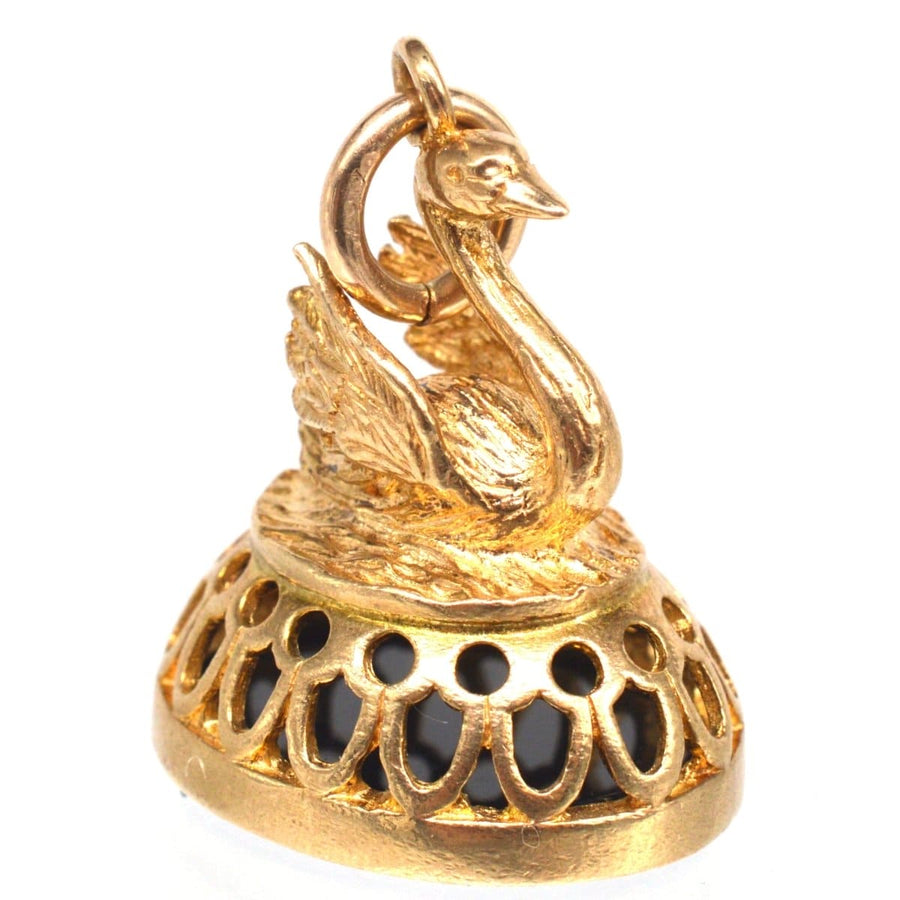 Vintage 9ct gold swan pendant with onyx, showcasing elegance and intricate craftsmanship.