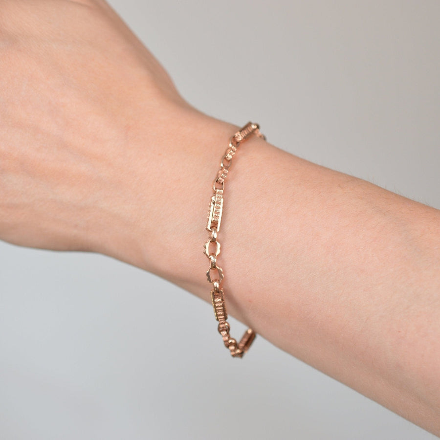 Vintage 9ct rose gold Albert fancy chain bracelet worn on a woman's wrist.