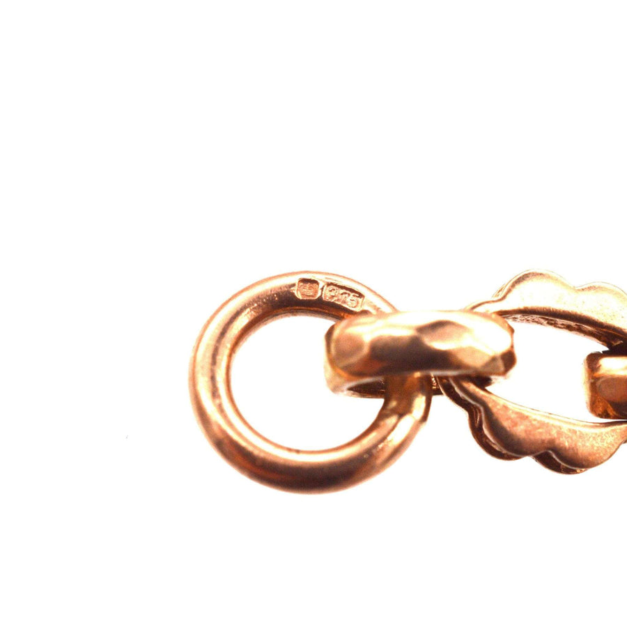 Close-up of vintage 9ct rose gold Albert chain bracelet clasp with hallmark, showcasing craftsmanship and design details.