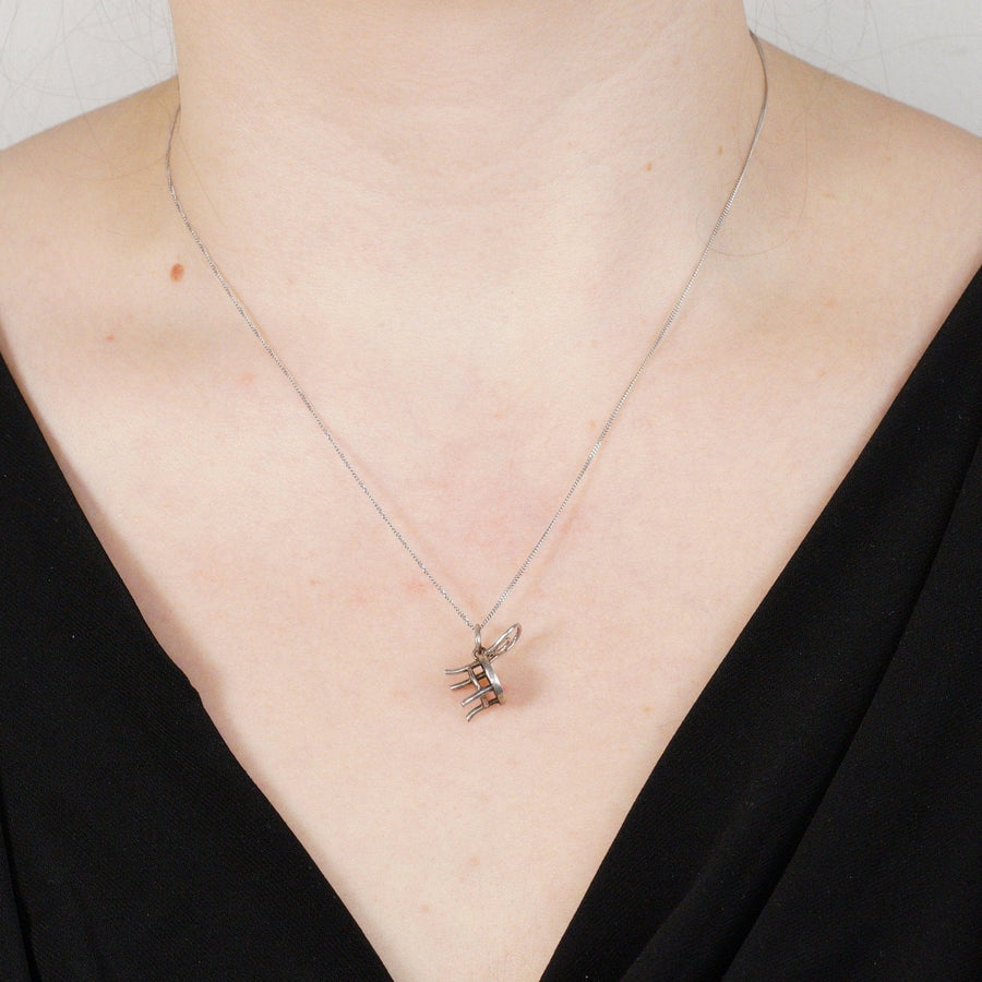 Close-up of a vintage 9ct white gold flat curb chain necklace worn by a model, featuring a simple design for everyday wear.