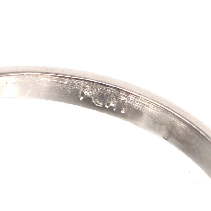 Close-up of the interior engraving of a vintage platinum ring marked "PLAT" for authenticity.
