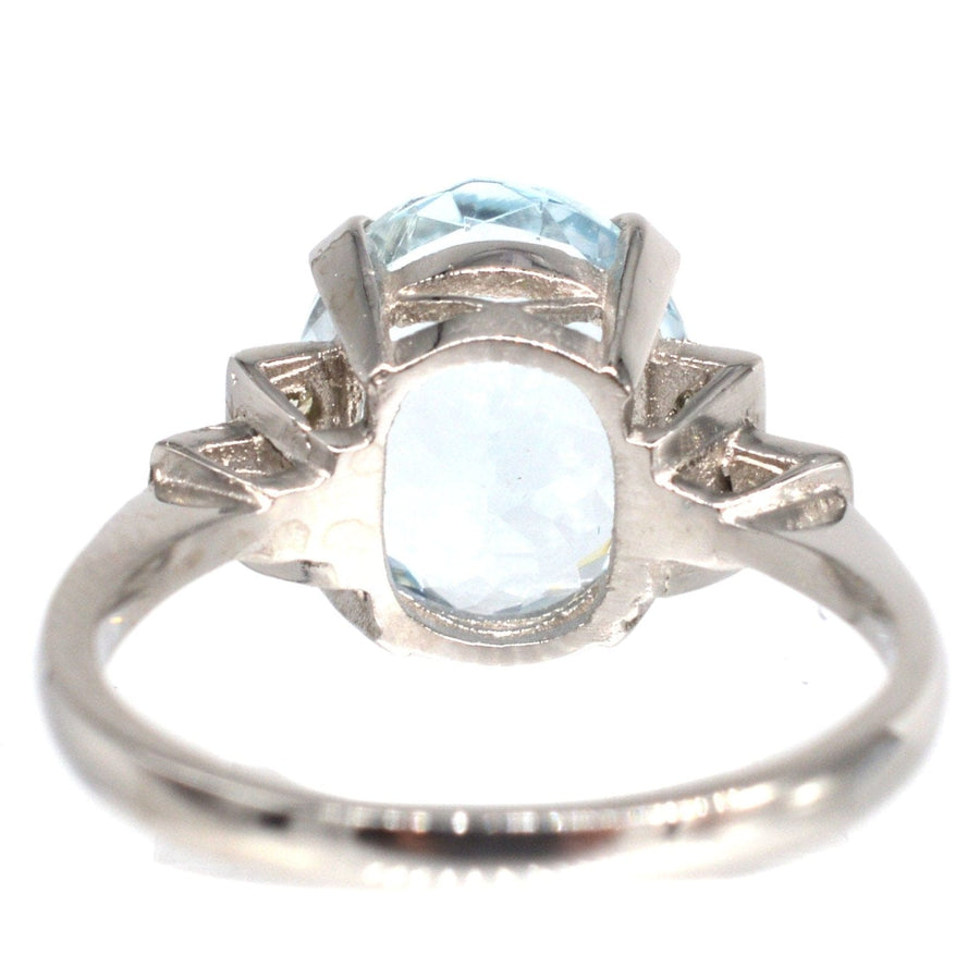Vintage platinum aquamarine ring with 3.6 carat light-blue stone and diamond shoulders, perfect for engagement or cocktail.