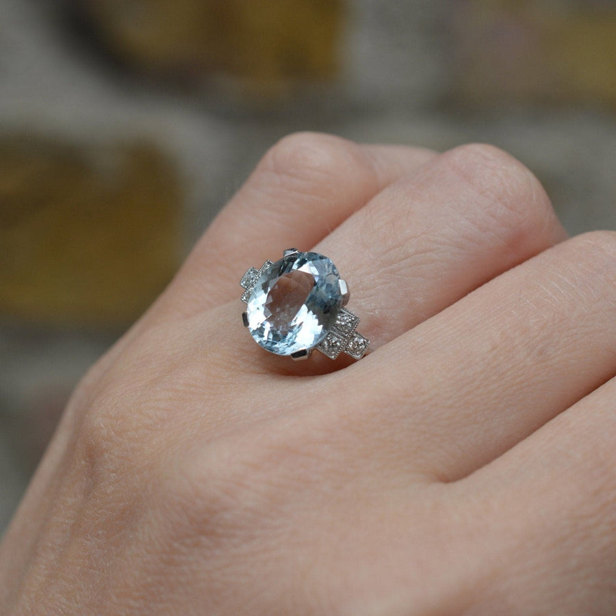 Vintage platinum aquamarine ring with diamond shoulders, showcasing a 3.6 carat oval aquamarine in light blue.