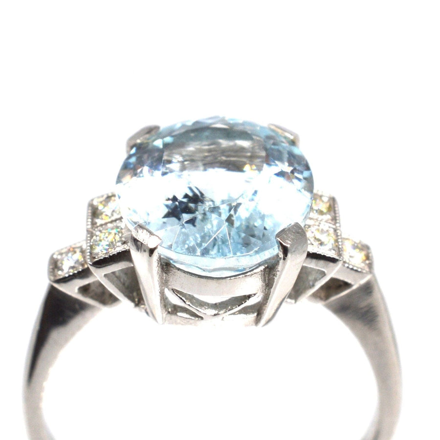 Vintage platinum ring featuring a large oval aquamarine and diamond shoulders, perfect for engagement or cocktail occasions.