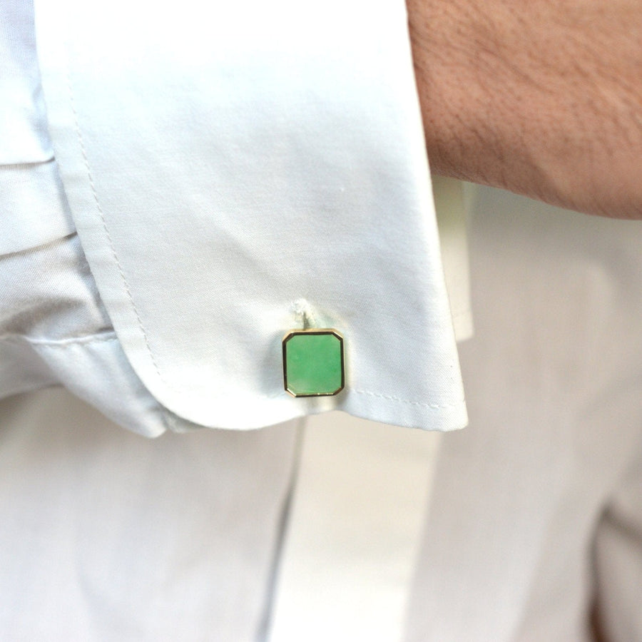 Vintage silver jade cufflinks showcased on a white shirt cuff, featuring green jadeite stones with a gold setting.