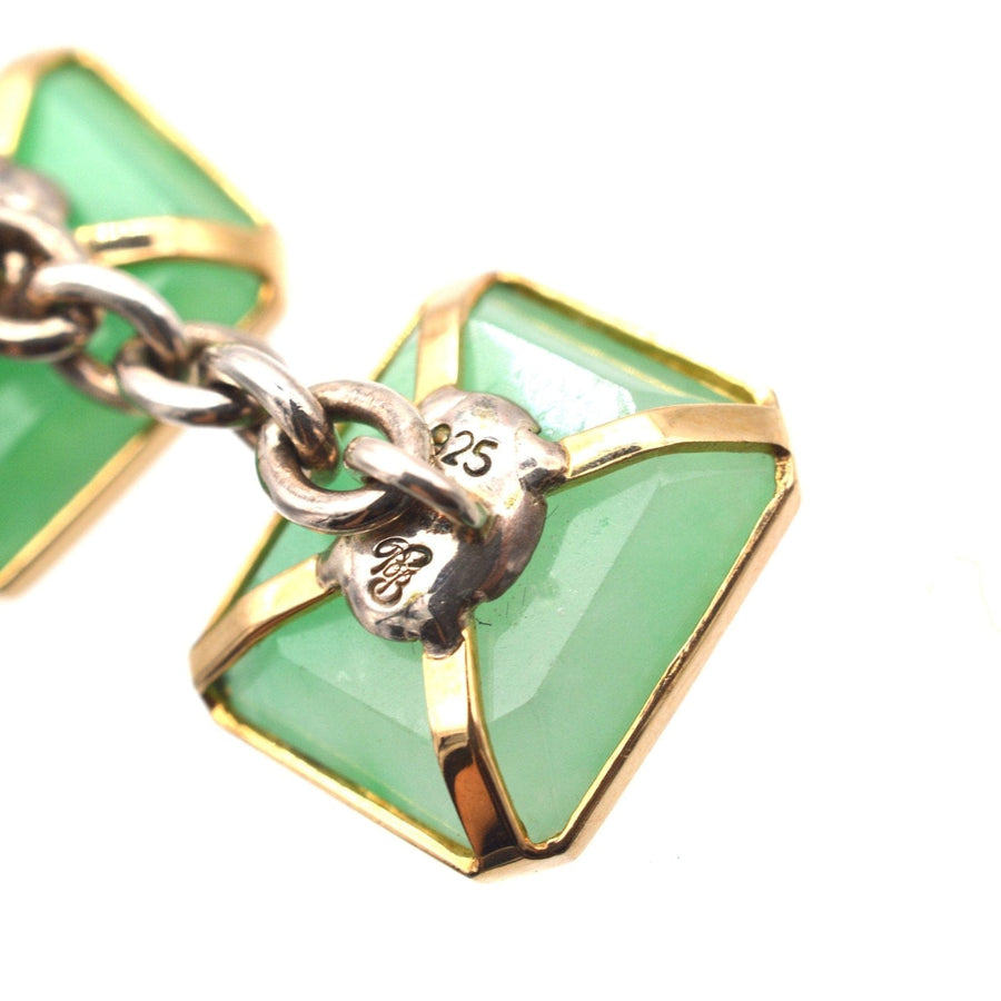 Vintage silver and jade Art Deco cufflinks featuring translucent green jadeite stones and a stylish gold setting.