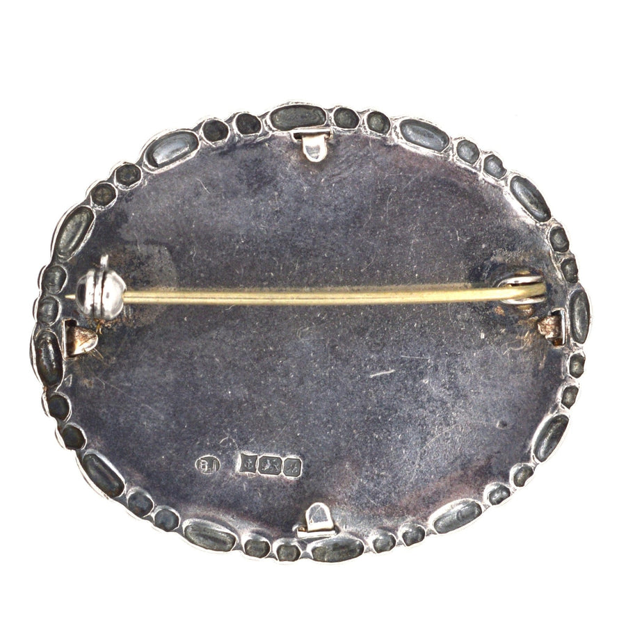 Vintage silver oval frame brooch featuring flower lace embroidery, crafted in Birmingham, 1975.