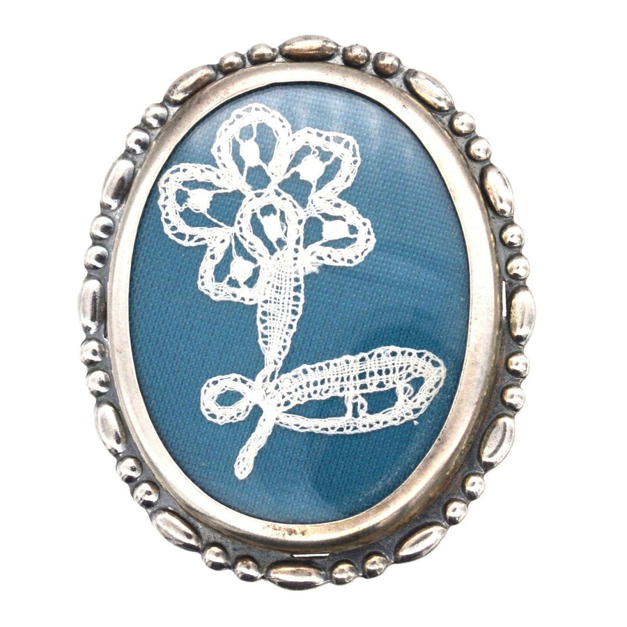 Vintage silver oval frame brooch featuring delicate flower lace embroidery from 1975 Birmingham.