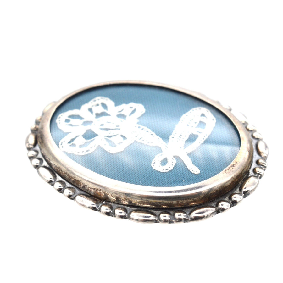 Vintage silver oval frame brooch featuring flower lace embroidery, made in Birmingham in 1975, charming keepsake.
