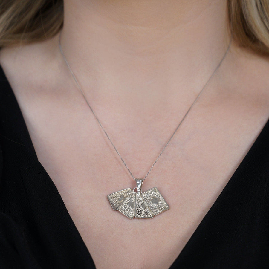 Vintage silver pendant featuring four aces playing cards, perfect for poker lovers and card game enthusiasts.