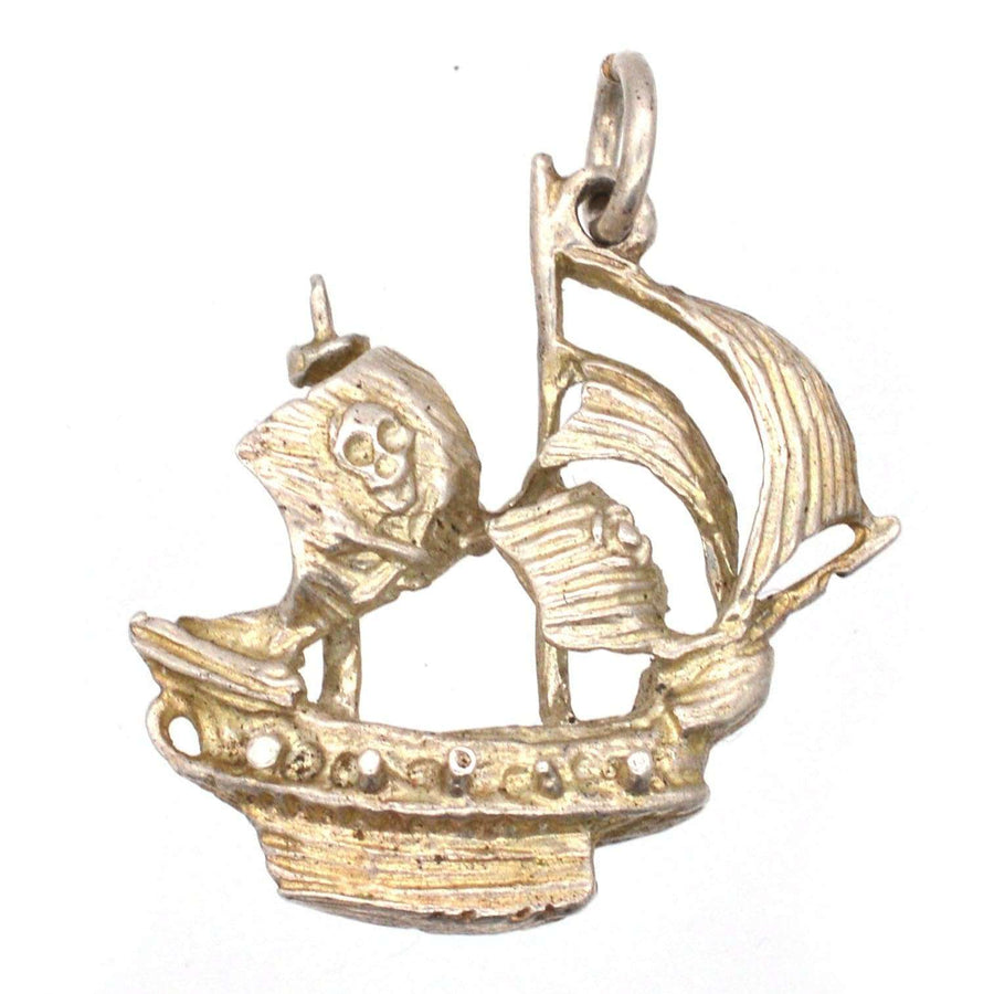 Vintage silver pirate ship pendant featuring a skull on the sail, perfect for treasure lovers.