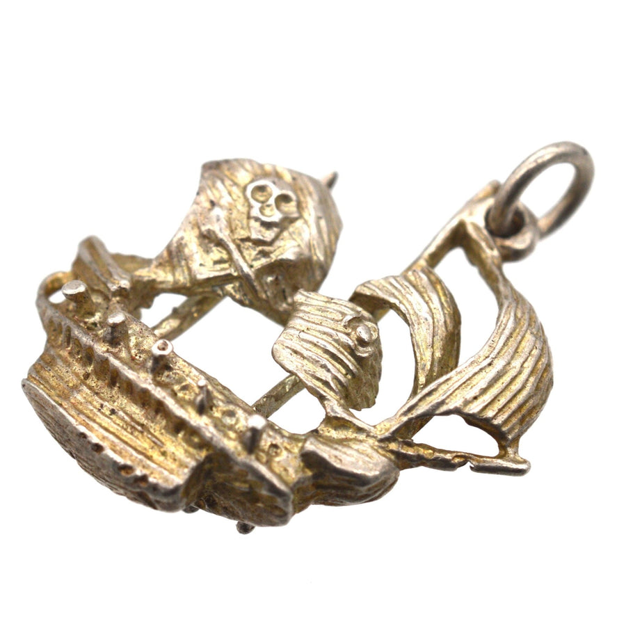 Vintage silver pirate ship pendant featuring a skull on the sail, perfect for treasure lovers.