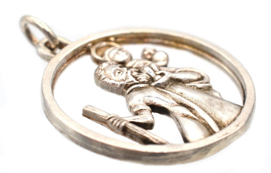 Vintage silver Saint Christopher round pendant featuring a detailed figure of St. Christopher with a gold halo.