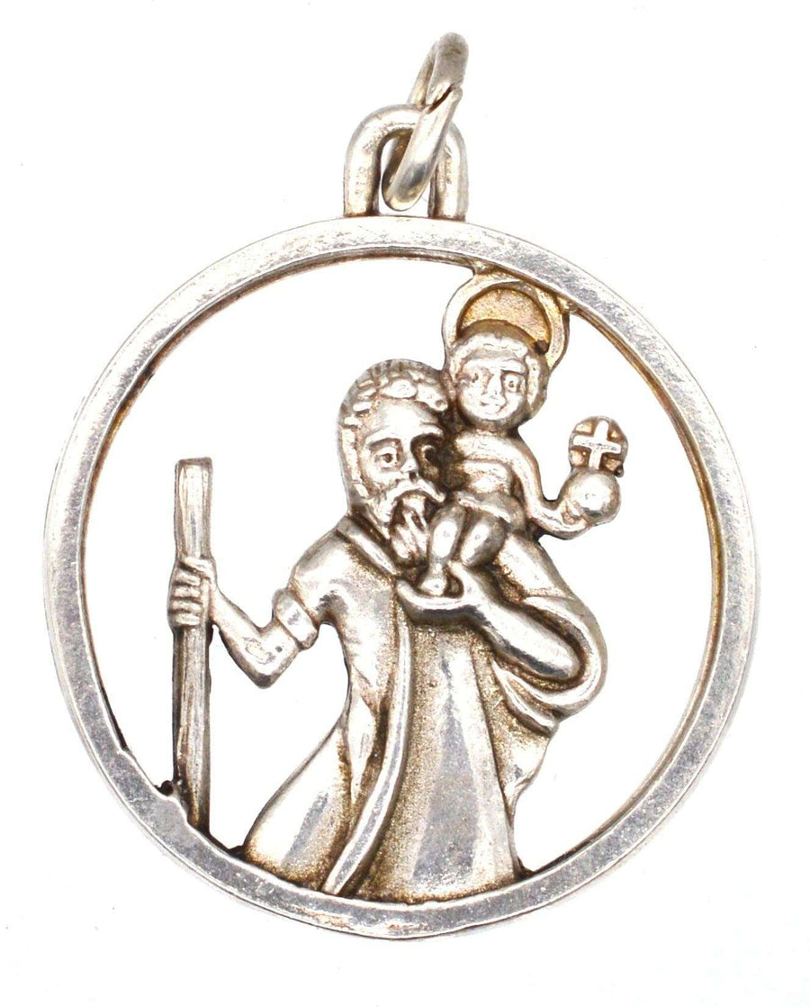 Vintage silver pendant featuring Saint Christopher carrying a child, with gold wash on the child's halo, circa 1960s.