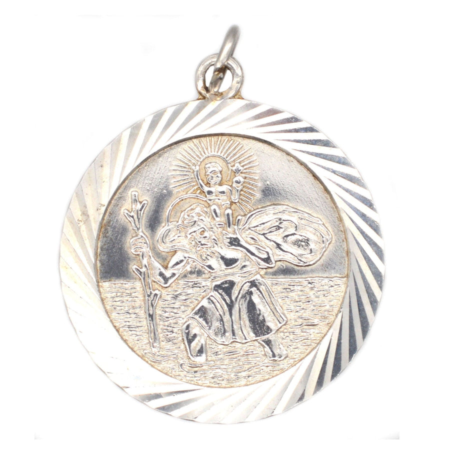 Vintage silver Saint Christopher pendant, featuring the saint carrying a child, ideal for travelers.