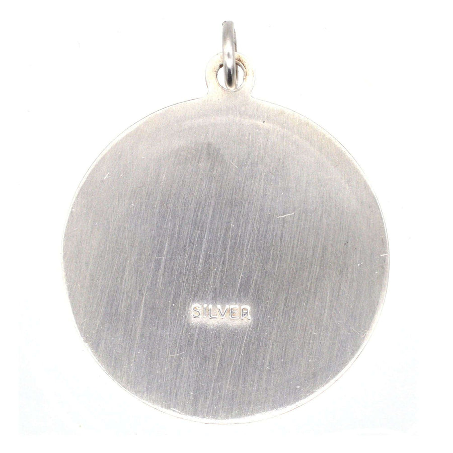 Vintage silver Saint Christopher round pendant with engraved back, circa 1970s, perfect for travelers.