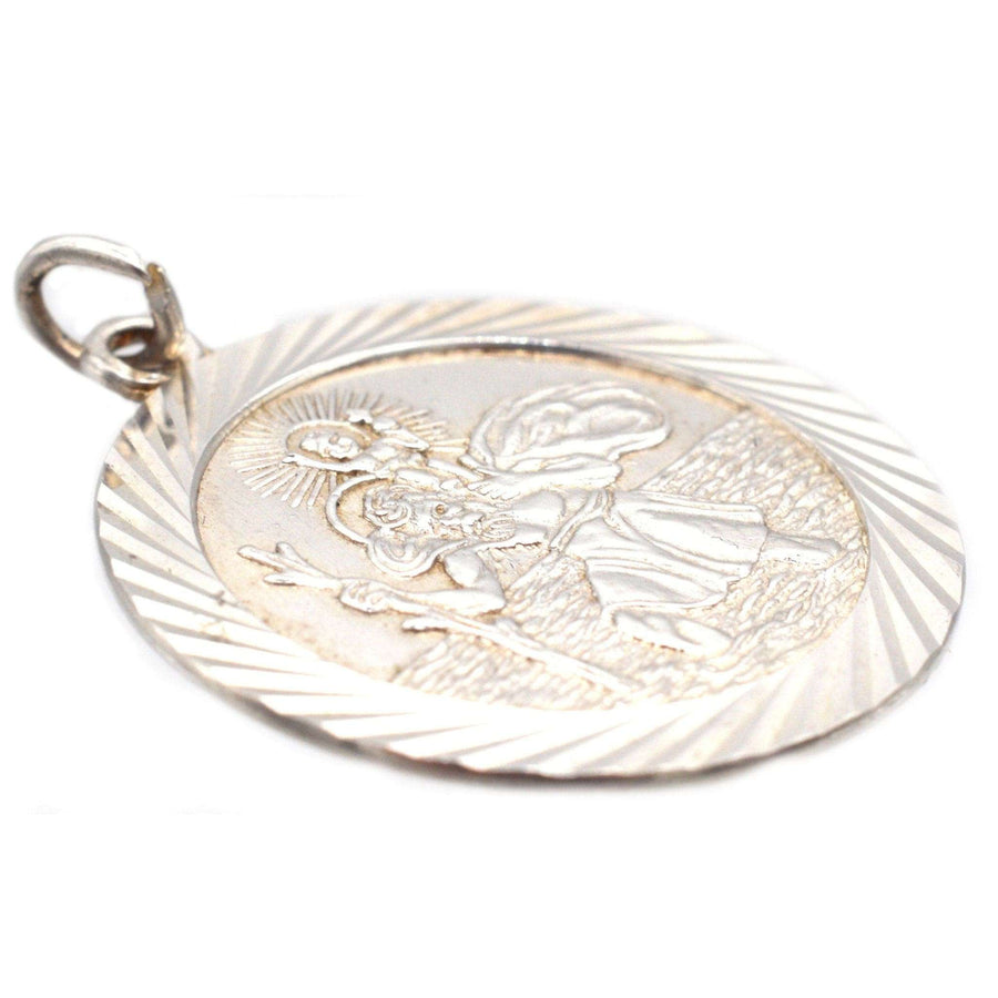 Vintage silver Saint Christopher round pendant depicting the patron saint of travellers, crafted in the 1970s.
