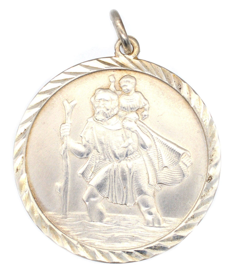 Vintage silver Saint Christopher pendant featuring St. Christopher carrying Christ, symbolizing protection for travelers.
