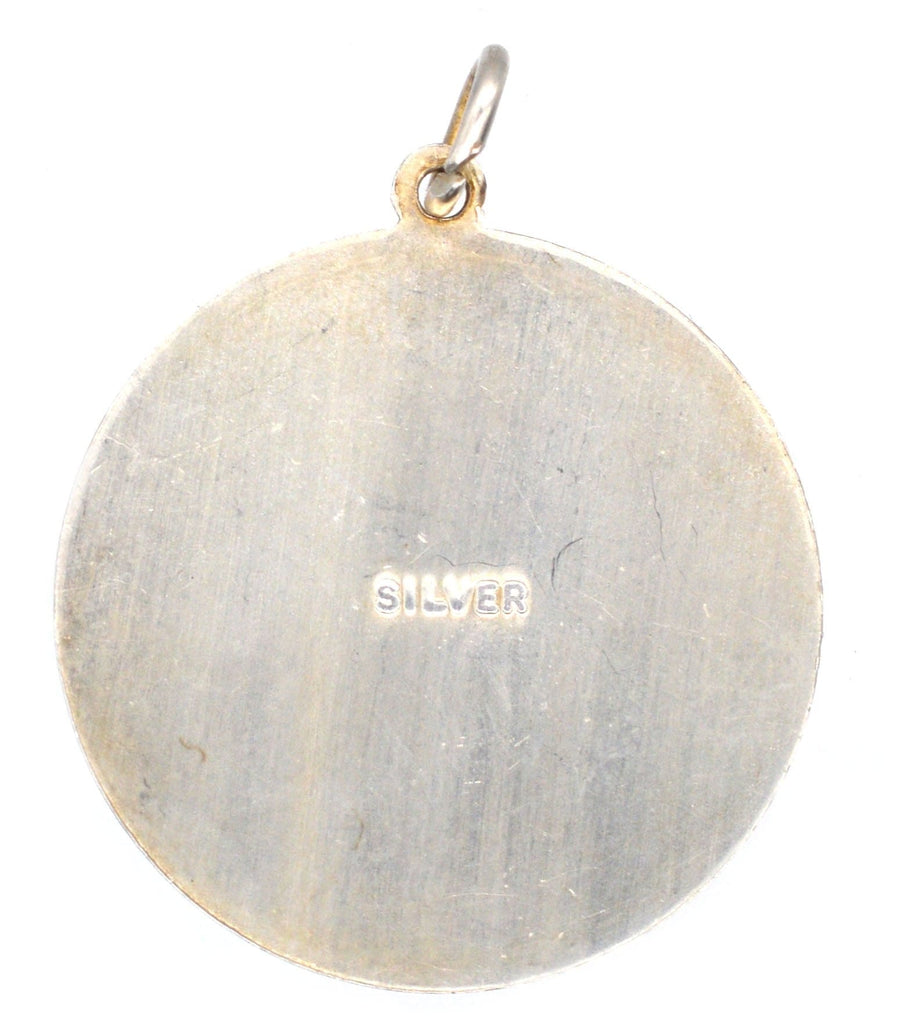 Back view of a vintage round silver pendant marked 'SILVER', from the 1970s, features Saint Christopher.