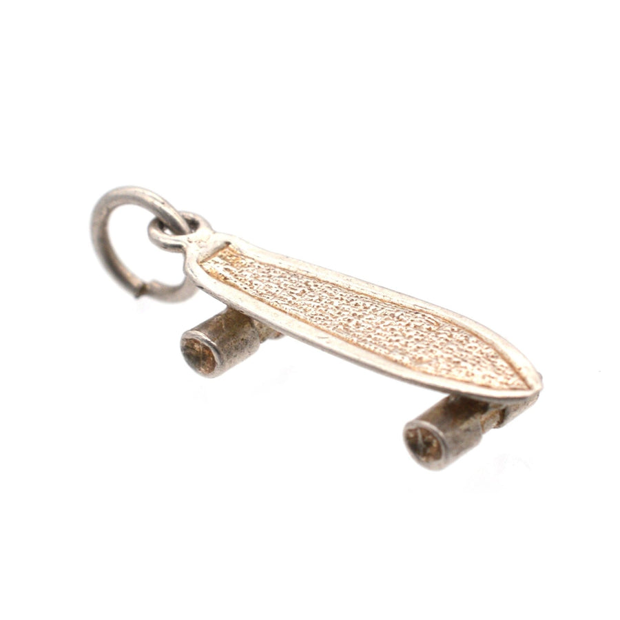 Vintage silver skateboard pendant charm, unique accessory for skateboard enthusiasts and jewelry lovers.