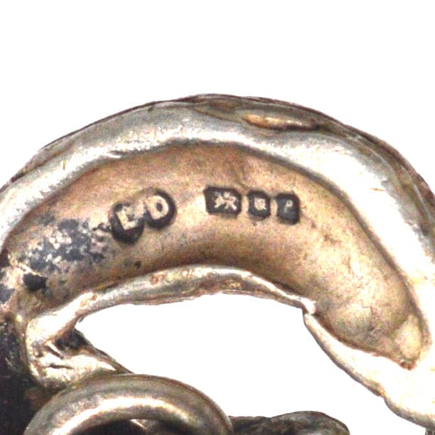 Close-up of hallmark on vintage silver cufflinks by Lexi Dick, showcasing unique craftsmanship and design details.